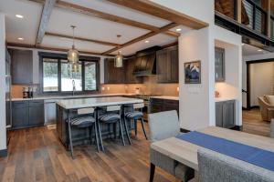 a kitchen with a table and some chairs in it at 6 Jakes Lane by Moonlight Basin Lodging in Big Sky