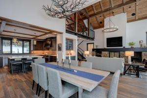 a dining room and kitchen with a table and chairs at 6 Jakes Lane by Moonlight Basin Lodging in Big Sky