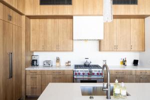 a kitchen with wooden cabinets and a stove top oven at 8C Jack Creek Cabin by Moonlight Basin Lodging in Big Sky