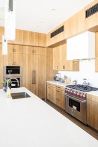 a kitchen with wooden cabinets and a stove top oven at 8C Jack Creek Cabin by Moonlight Basin Lodging in Big Sky