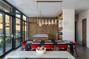 a kitchen and dining room with a table and red chairs at 7 Speedwell Drive by Moonlight Basin Lodging in Big Sky