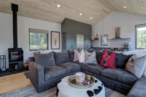 a living room with a couch and a table at 17 Lake Cabin by Moonlight Basin Lodging in Big Sky