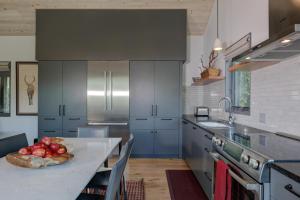 a kitchen with a table with a bowl of fruit on it at 17 Lake Cabin by Moonlight Basin Lodging in Big Sky