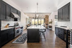 a kitchen with black cabinets and a white counter top at 16 Wildwood by Moonlight Basin Lodging in Big Sky