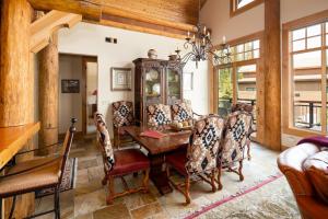 a dining room with a wooden table and chairs at Penthouse 4 by Moonlight Basin Lodging in Big Sky