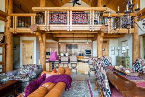 a large living room with a couch and a kitchen at Penthouse 4 by Moonlight Basin Lodging in Big Sky