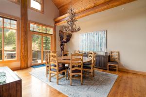 a dining room with a wooden table and chairs at Penthouse 3 by Moonlight Basin Lodging in Big Sky