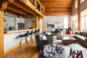 a living room with a couch and a table at Penthouse 1 by Moonlight Basin Lodging in Big Sky