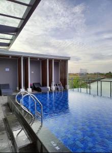 a large pool with blue water in a building at One Residence #11AI in Batam Center