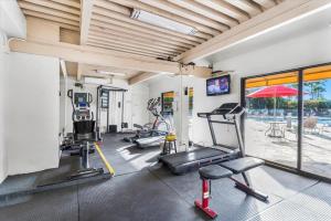 a gym with several treadmills and machines in a room at Cozy Condo in Kihei at Kamaole Sands Building 3 Unit 202 in Wailea