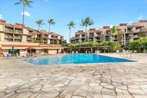 a swimming pool in front of a resort at Cozy Condo in Kihei at Kamaole Sands Building 3 Unit 202 in Wailea