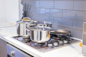 a group of pots and pans on a stove in a kitchen at Elegant 3 bed house in the heart of London in London