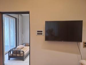 a flat screen tv on a wall in a room at At par with 5 star hotel.. in Pune