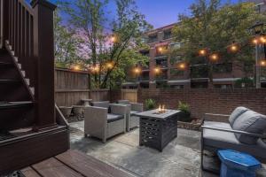 a patio with chairs and a table and a building at The BEST Gorgeous & Luxurious Home Walk to Metro in Arlington