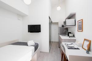 a room with a bed and a desk and a microwave at Heritage Collection on Chinatown - Mobile App Check-In in Singapore