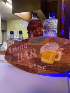 a wooden surfboard sitting on a table with bottles of water at HOTEL1800 in Seki
