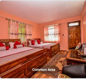 a bedroom with two beds and a living room at Tharbaling HomeStay in Darjeeling