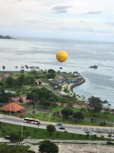 an orange balloon is flying over the water at Casa Hany in Panama City