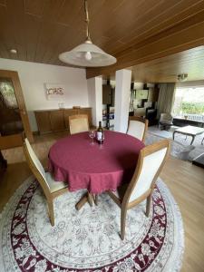 a dining room with a purple table and chairs at Entire house, quiet city location, garden, parking in Bielefeld