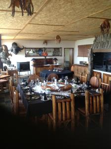 a large dining room with a table and chairs at Aloegrove Safari Lodge in Otjiwarongo
