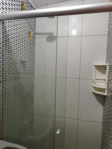 a bathroom with a shower with a glass door at Casa inteira in Solânea