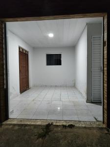 an empty room with white walls and a door at Casa inteira in Solânea +13 photos