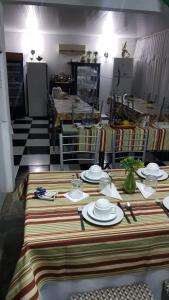 a table with plates and utensils on top of it at Hotel Bella Unión in Bella Unión