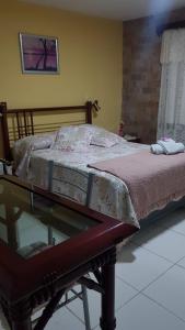 a bed sitting on a glass table in a room at Hotel Bella Unión in Bella Unión