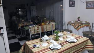 a room with two tables with plates and dishes on them at Hotel Bella Unión in Bella Unión