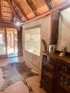 ein Wohnzimmer mit einem großen Fenster in einem Haus in der Unterkunft Nyala Luxury Safari Tents in Marloth Park