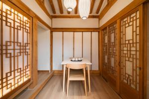 a small table in a room with windows at Luxury hanok with private bathtub - SN08 in Seoul