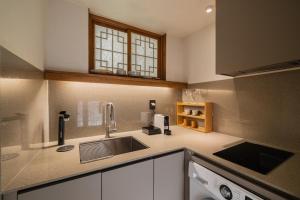 a kitchen with a sink and a counter top at Luxury hanok with private bathtub - SN08 in Seoul