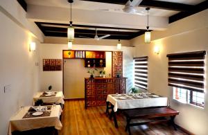 a dining room with two tables in a restaurant at Johns Solitude in Anachal