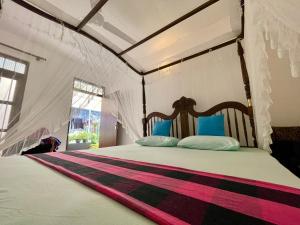 a bedroom with a bed in a tent at Sun & Tree HomeStay (With Green Nature View) in Mirissa