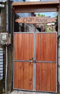 a wooden gate with a sign that reads child house at Chill House Flores in Flores