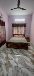 a bedroom with a bed and a ceiling fan at Diskul's HomeStay in Thiruvalla