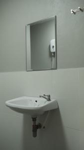 a white sink in a bathroom with a mirror at Namas Kan Farmstay in Kanchanaburi