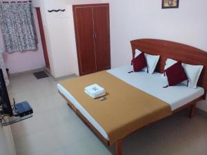 a bedroom with a bed with a telephone on it at Royal Green Accommodation Chennai Airport in Chennai