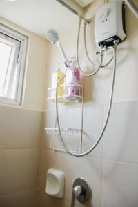 a bathroom with a shower head and a sink at Spacious 3 Bedroom Appartement @Avida Allgauers in Iloilo City