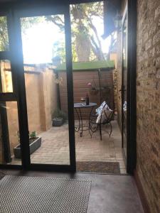 an open door to a patio with a table at Kyasaja Home away from home in Pretoria