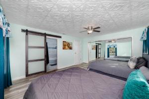 a bedroom with a bed and a ceiling fan at BELVEDERE Home with big pool-near Houston Downtown in Katy +111 photos
