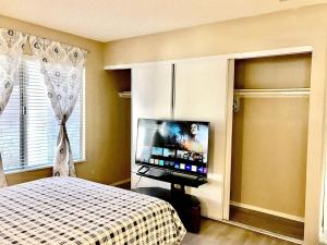 a bedroom with a bed and a flat screen tv at Independent bedroom with private bathroom#2 in Las Vegas