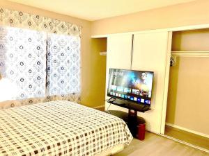 a bedroom with a bed and a flat screen tv at Independent bedroom with private bathroom#2 in Las Vegas