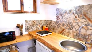 a kitchen with a sink and a counter top at Casa Betulla in Valmorel