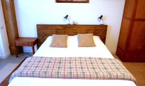 a bedroom with a white bed with two pillows at Casa Betulla in Valmorel
