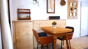 a kitchen with a wooden table and chairs at Casa Betulla in Valmorel +18 photos