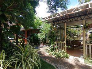 a patio of a house with a roof at Marino Bungalows in Bantayan Island