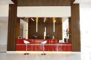 two men sitting at a reception desk in a lobby at Keys Select by Lemon Tree Hotels, Whitefield, Bengaluru in Bangalore