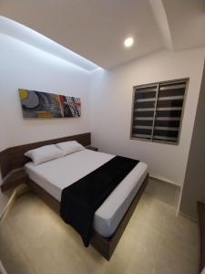 a bedroom with a bed and a window in it at Grace Hotel Guaranda 