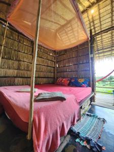 a bedroom with a bed in a hut at Sweet Jungle Glamping in Koh Rong Island